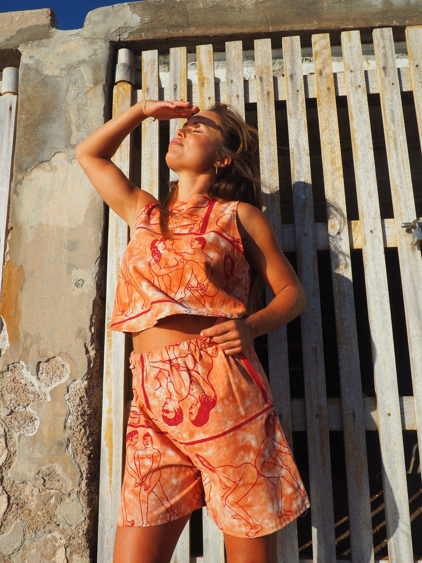 Up-cycled vintage cotton shorts with elastic waist and printed karma sutra design in burnt orange.