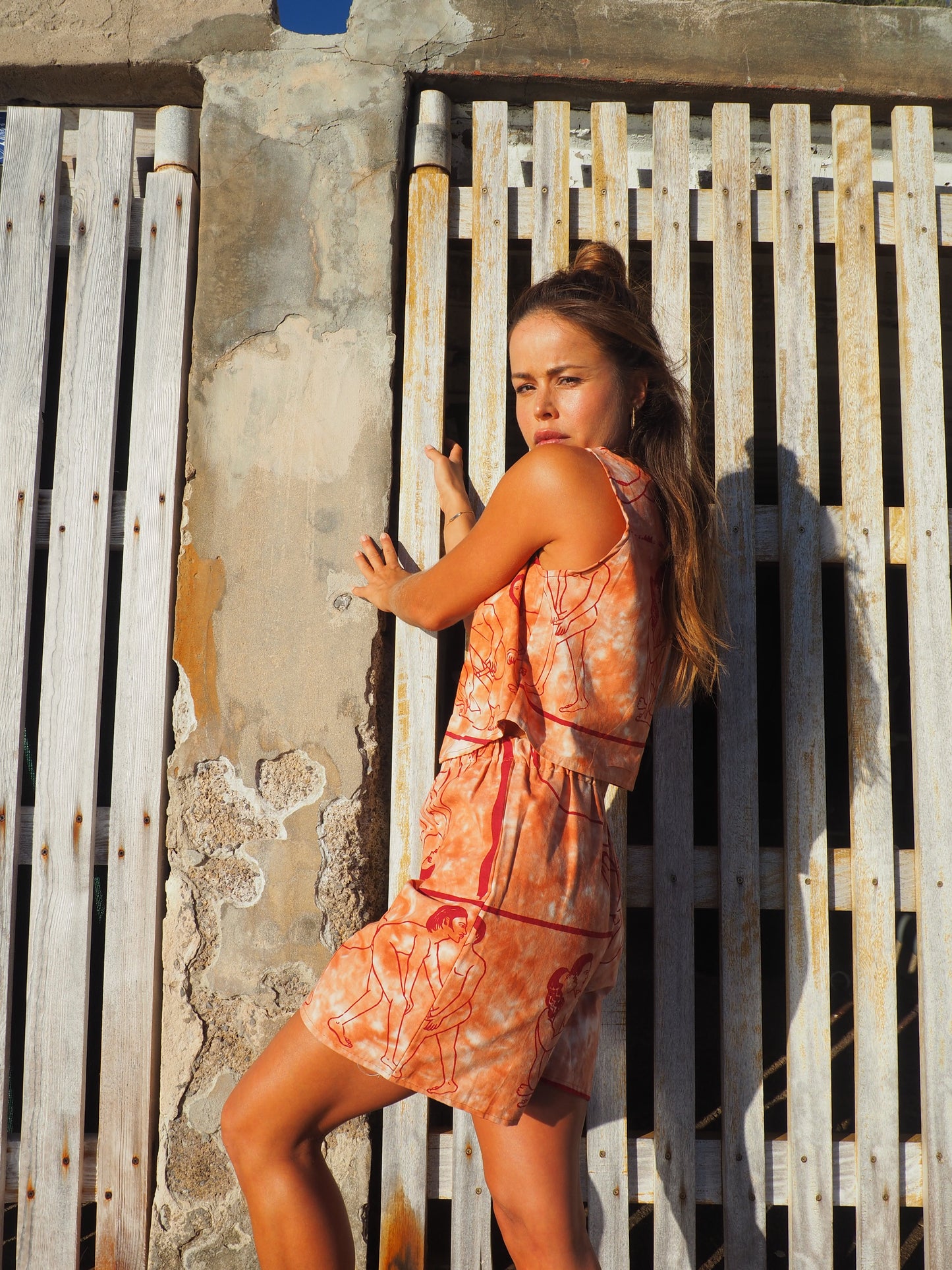 Up-cycled vintage cotton shorts with elastic waist and printed karma sutra design in burnt orange.