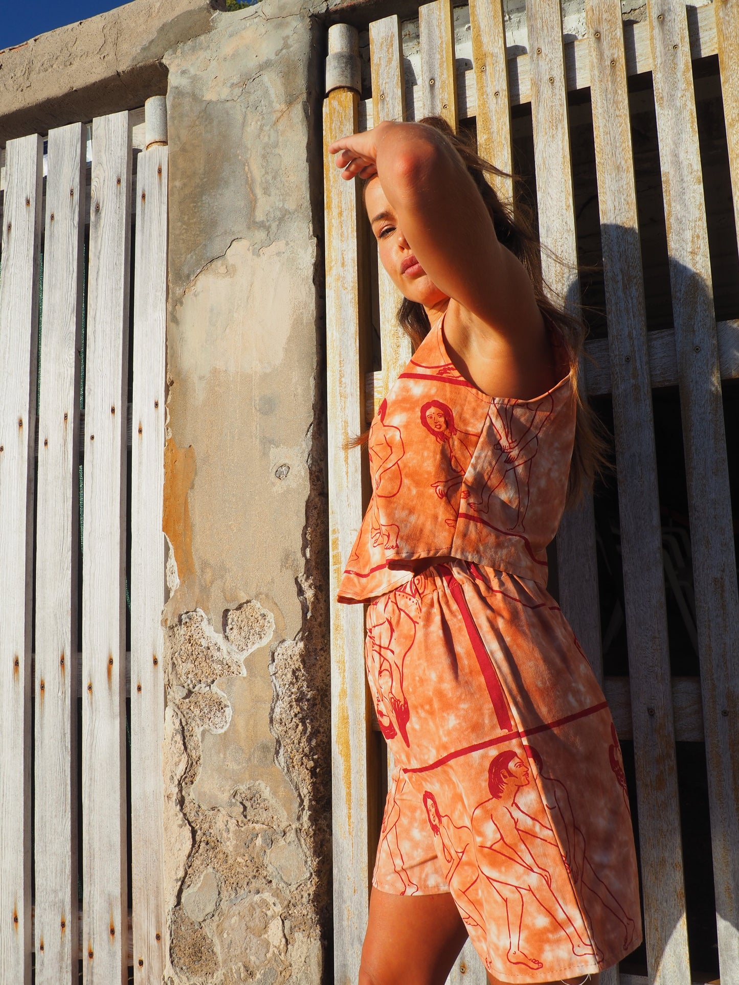 Up-cycled vintage cotton shorts with elastic waist and printed karma sutra design in burnt orange.
