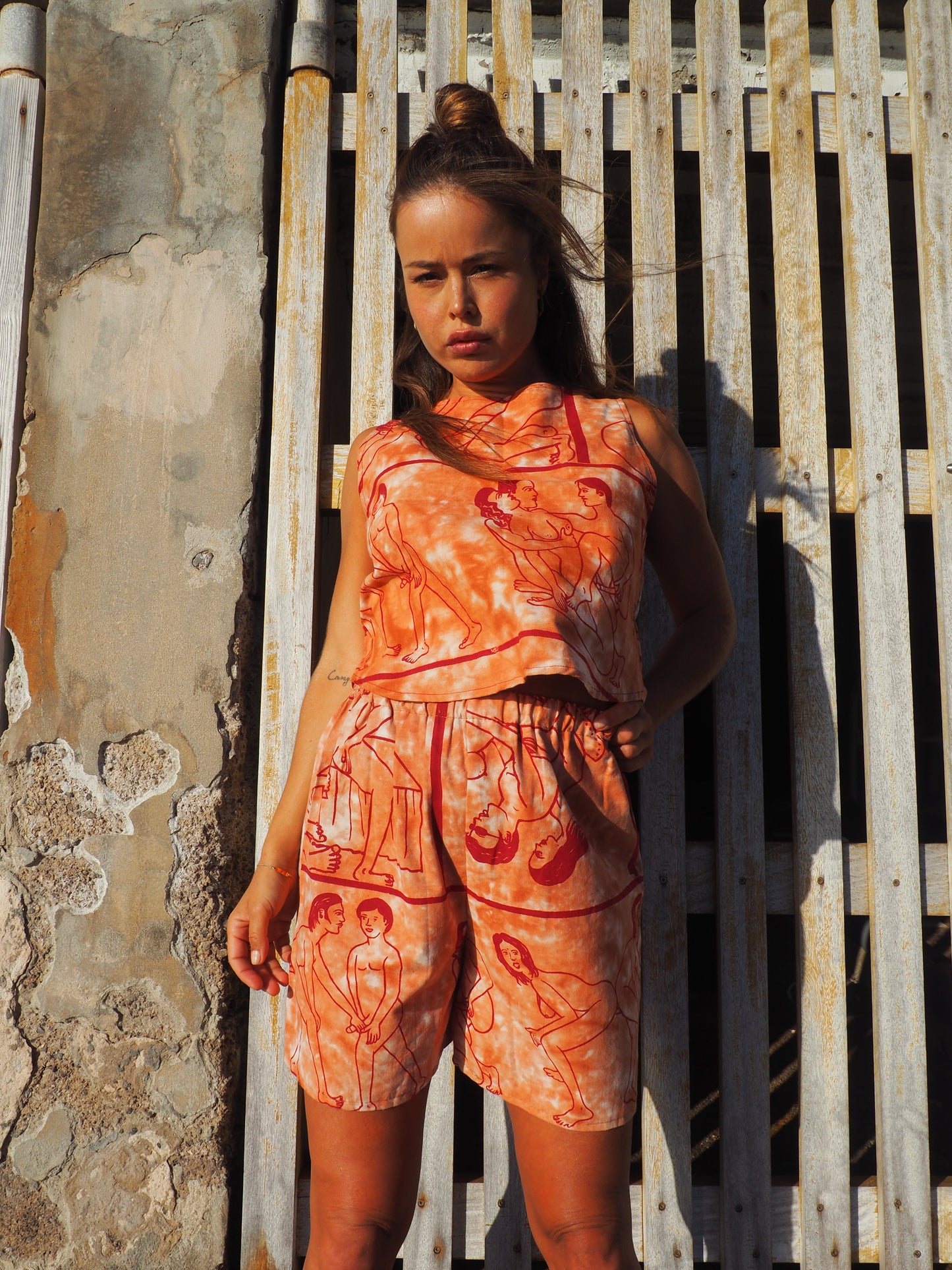 Up-cycled vintage cotton shorts with elastic waist and printed karma sutra design in burnt orange.
