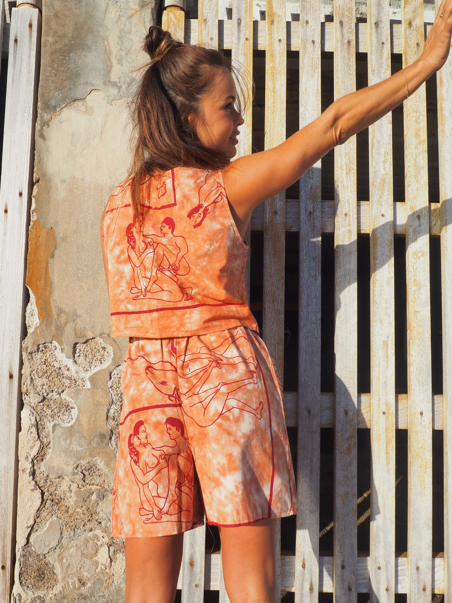 Up-cycled vintage cotton shorts with elastic waist and printed karma sutra design in burnt orange.
