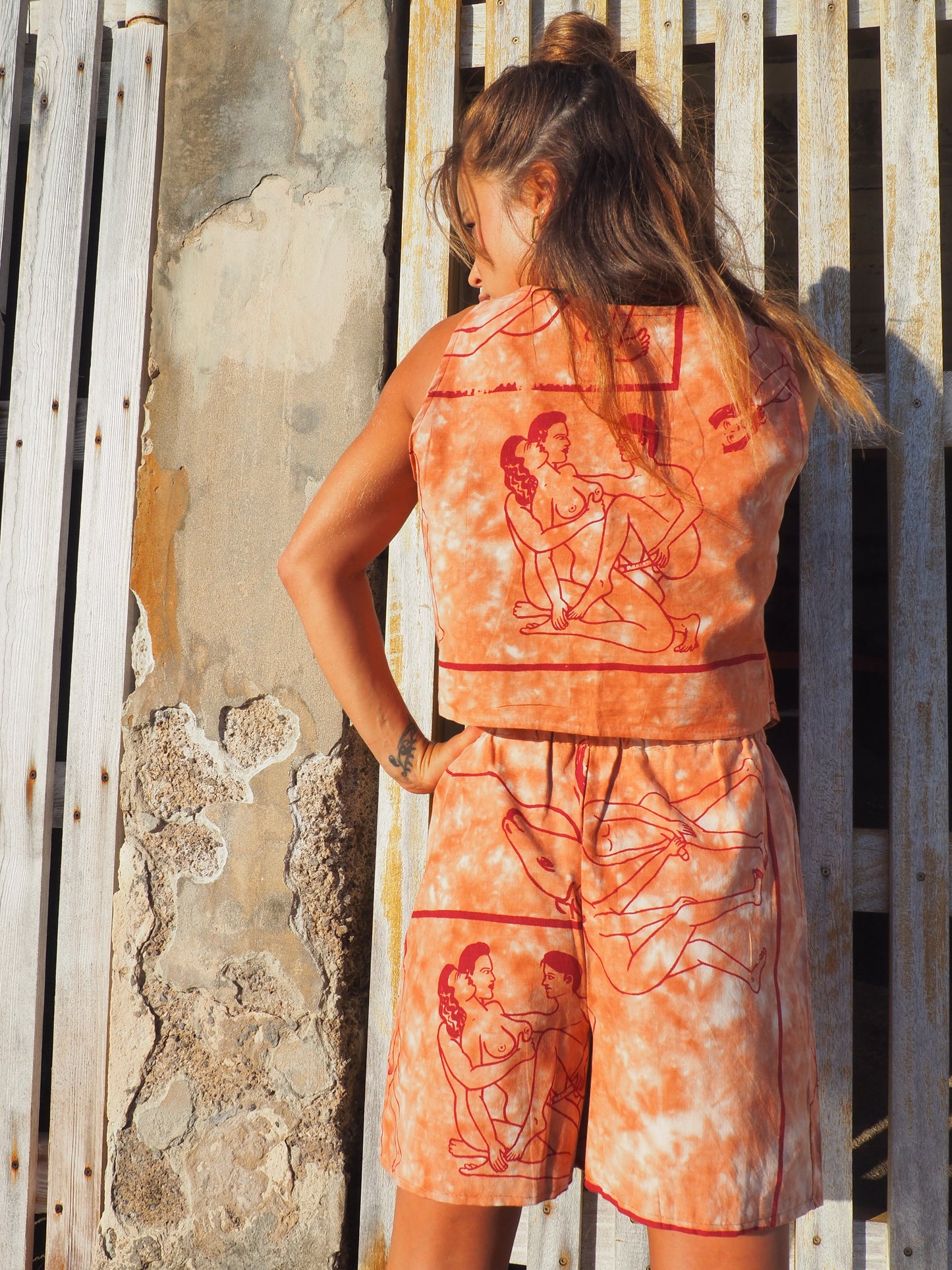 Up-cycled vintage cotton shorts with elastic waist and printed karma sutra design in burnt orange.