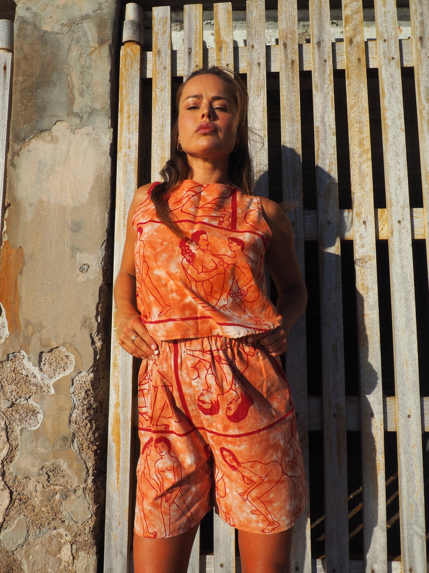 Up-cycled vintage cotton shorts with elastic waist and printed karma sutra design in burnt orange.
