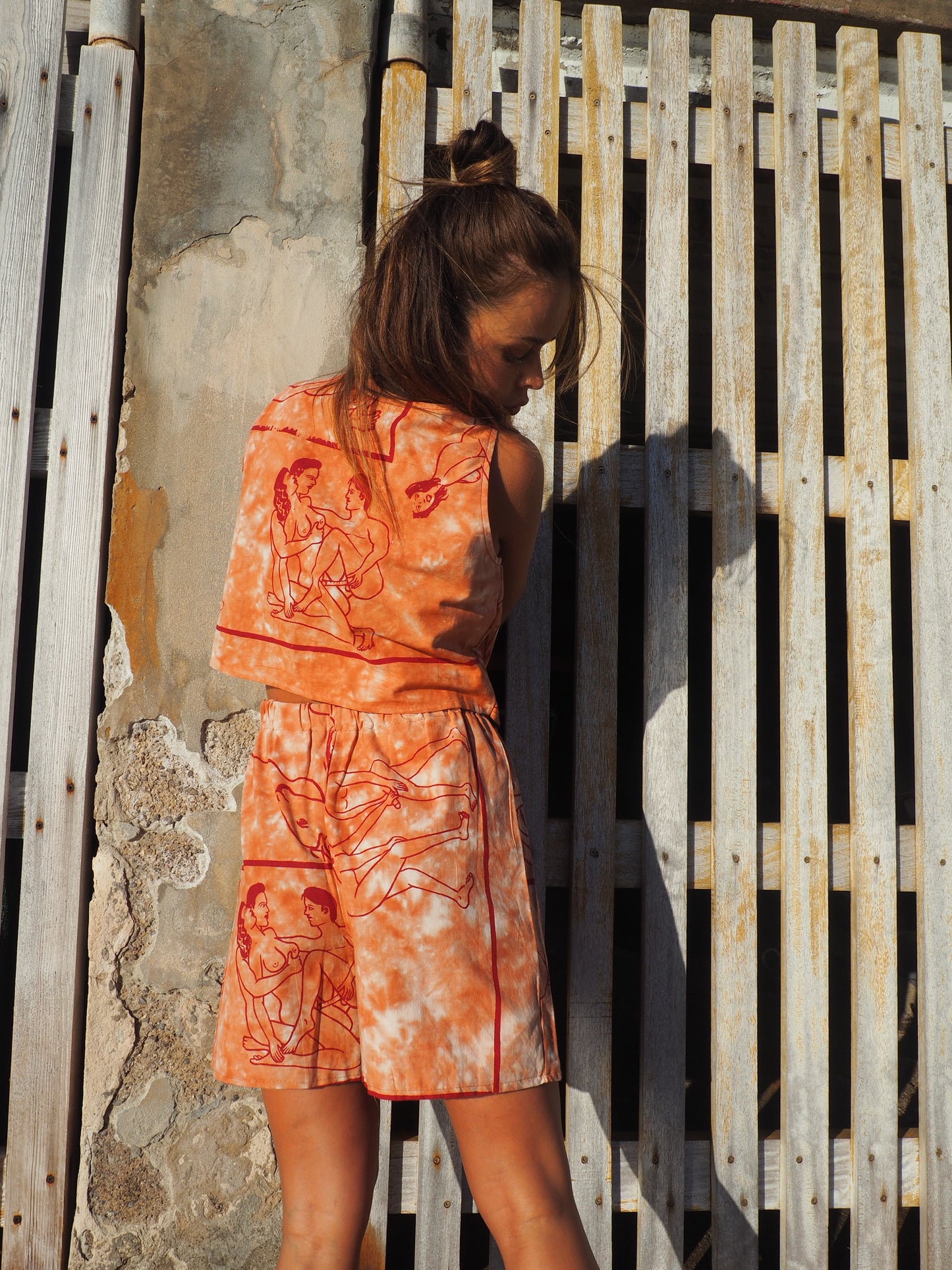 Up-cycled vintage cotton shorts with elastic waist and printed karma sutra design in burnt orange.