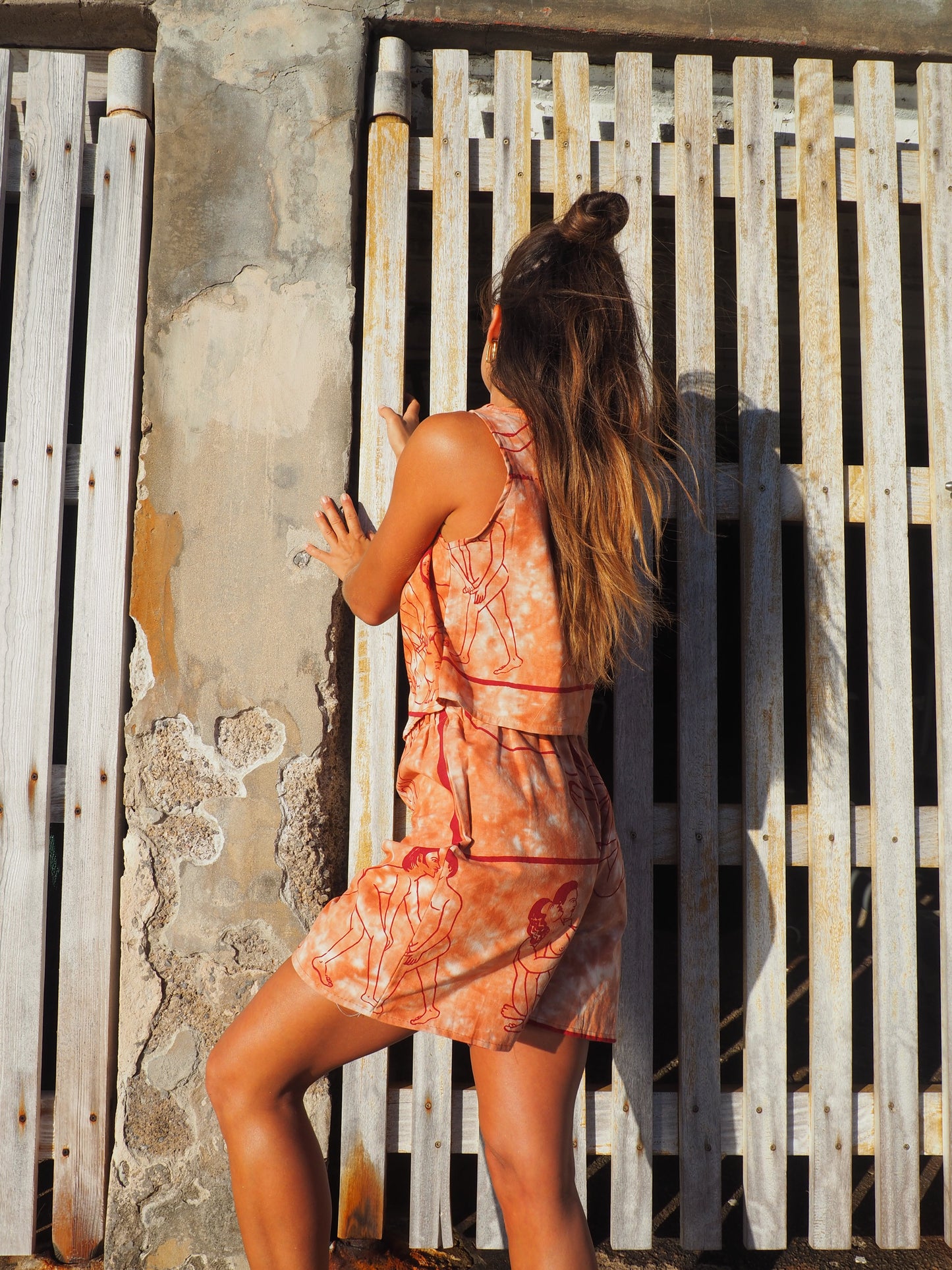 Up-cycled vintage cotton shorts with elastic waist and printed karma sutra design in burnt orange.