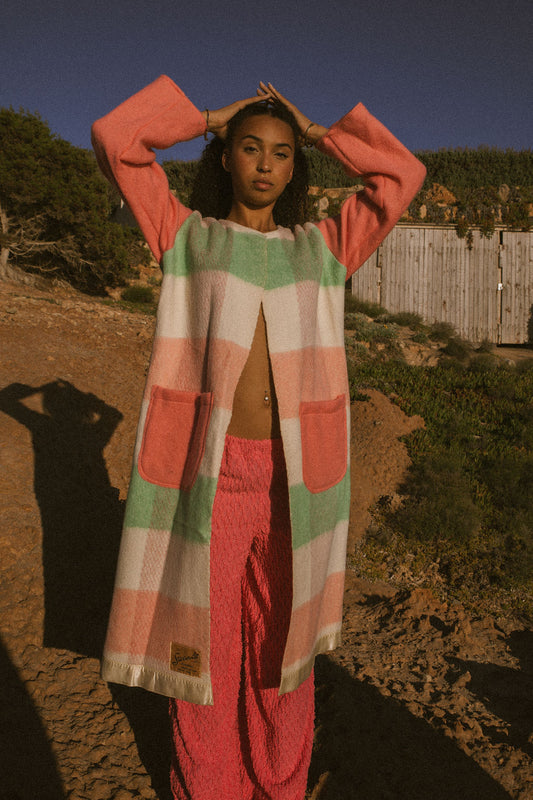 Recycled pastel patchwork jacket with checked sleeves and pink body, made from vintage blankets