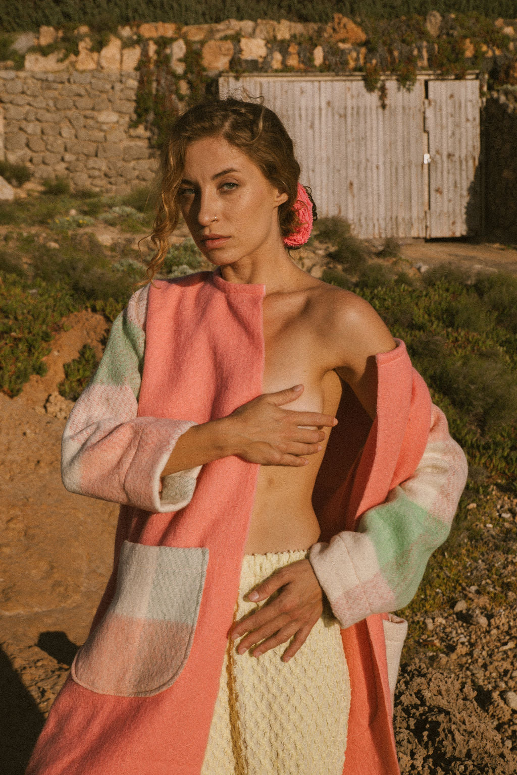 Recycled pastel patchwork jacket with checked sleeves and pink body, made from vintage blankets