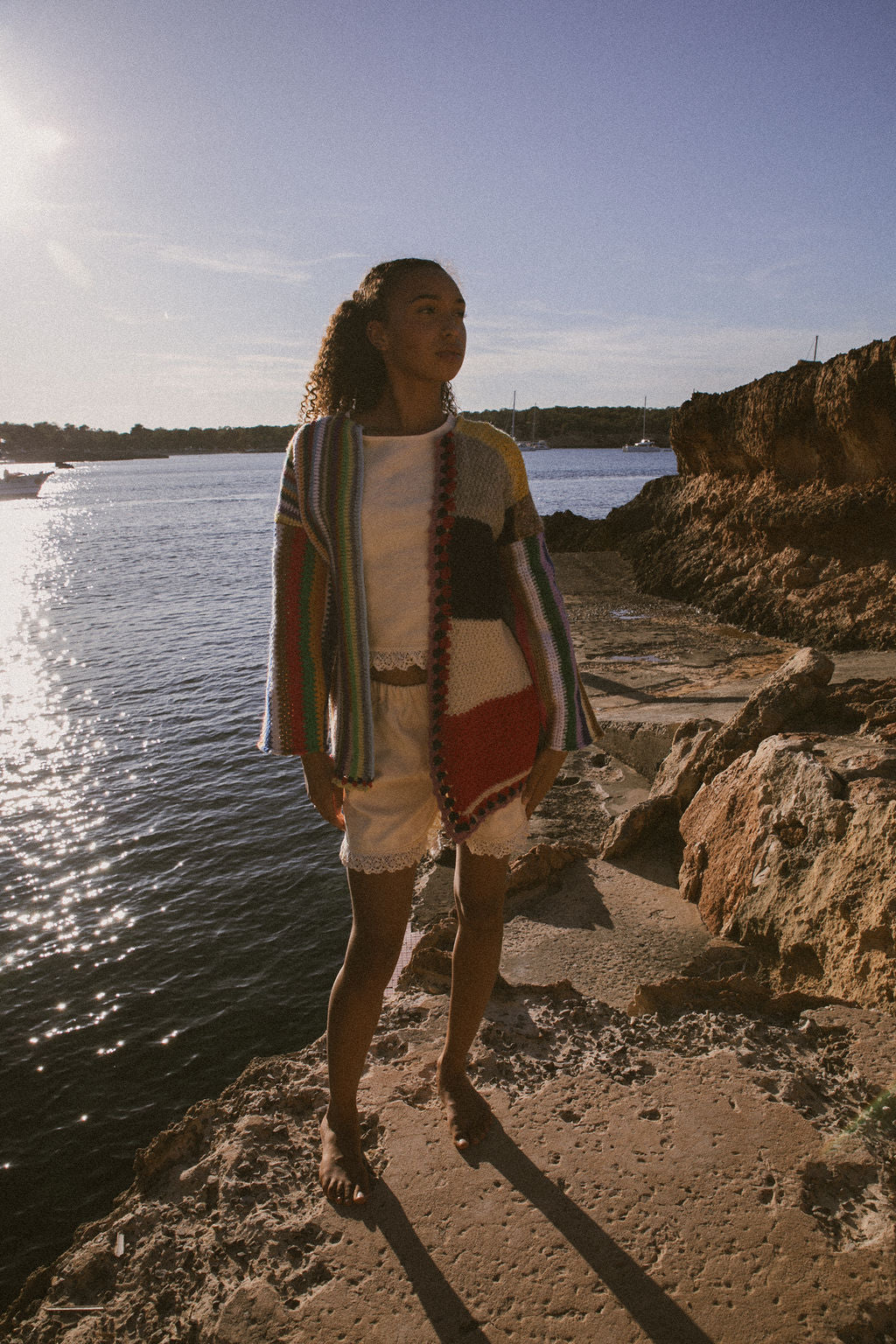 Rainbow striped patchwork upcycled crochet jacket made from vintage blankets, handmade in Ibiza.