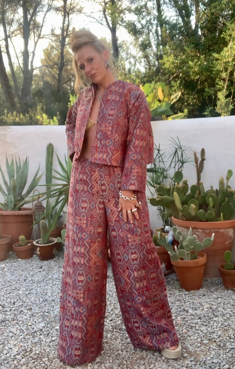 Very cool 2 piece sets made by Vagabond Ibiza from 1970’s upholstery fabrics in burgundy wide cropped long sleeve jackets and wide leg trousers with elastic waist