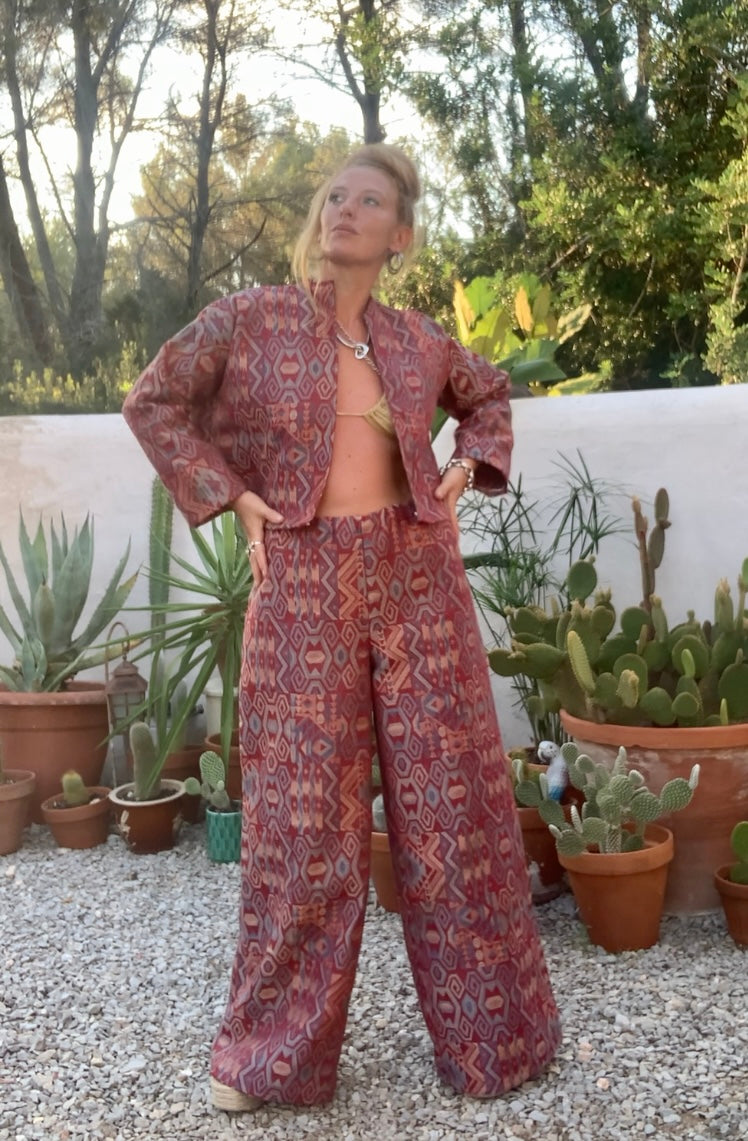 Very cool 2 piece sets made by Vagabond Ibiza from 1970’s upholstery fabrics in burgundy wide cropped long sleeve jackets and wide leg trousers with elastic waist