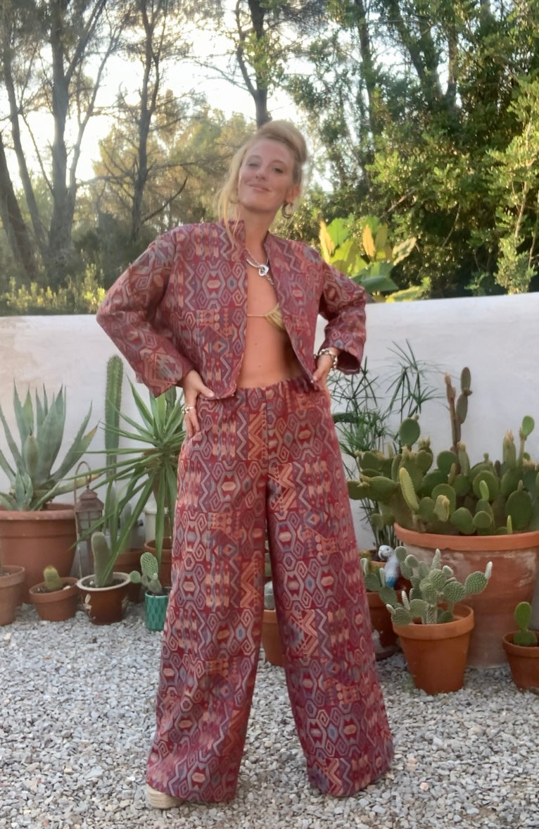 Very cool 2 piece sets made by Vagabond Ibiza from 1970’s upholstery fabrics in burgundy wide cropped long sleeve jackets and wide leg trousers with elastic waist
