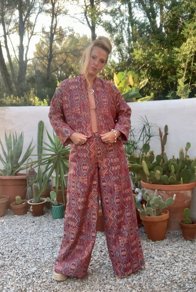 Very cool 2 piece sets made by Vagabond Ibiza from 1970’s upholstery fabrics in burgundy wide cropped long sleeve jackets and wide leg trousers with elastic waist