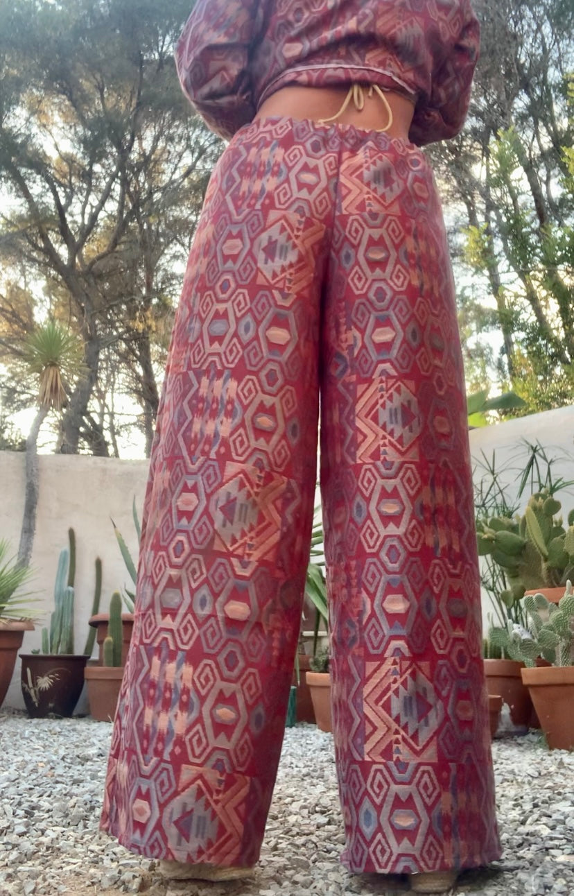 Very cool 2 piece sets made by Vagabond Ibiza from 1970’s upholstery fabrics in burgundy wide cropped long sleeve jackets and wide leg trousers with elastic waist