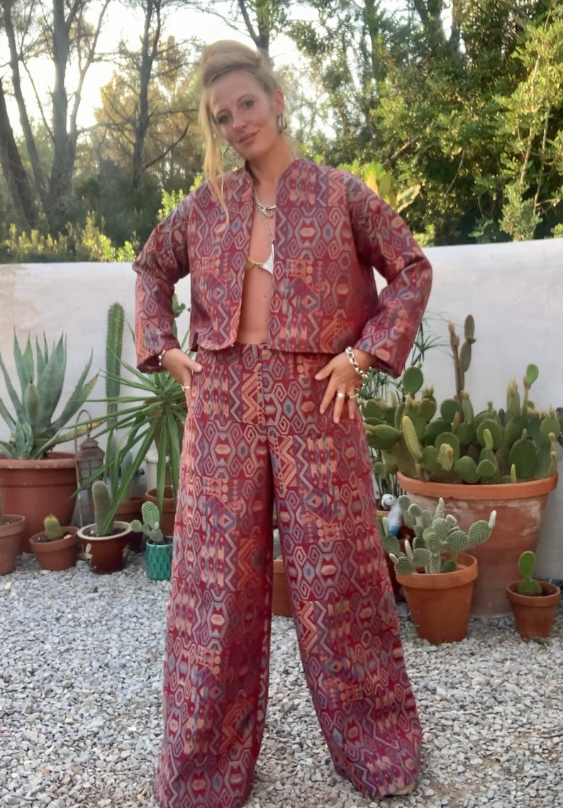 Very cool 2 piece sets made by Vagabond Ibiza from 1970’s upholstery fabrics in burgundy wide cropped long sleeve jackets and wide leg trousers with elastic waist