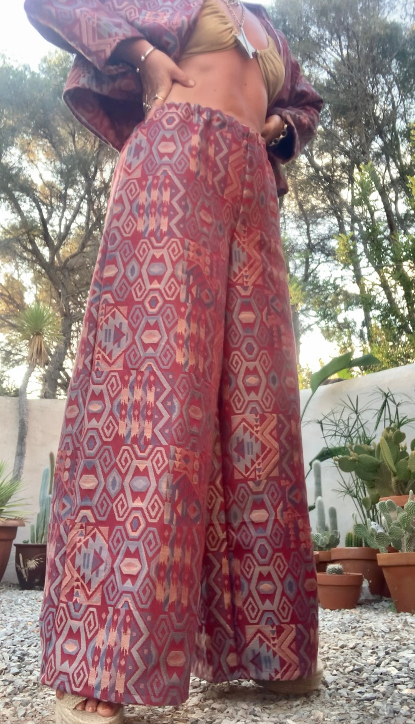 Very cool 2 piece sets made by Vagabond Ibiza from 1970’s upholstery fabrics in burgundy wide cropped long sleeve jackets and wide leg trousers with elastic waist