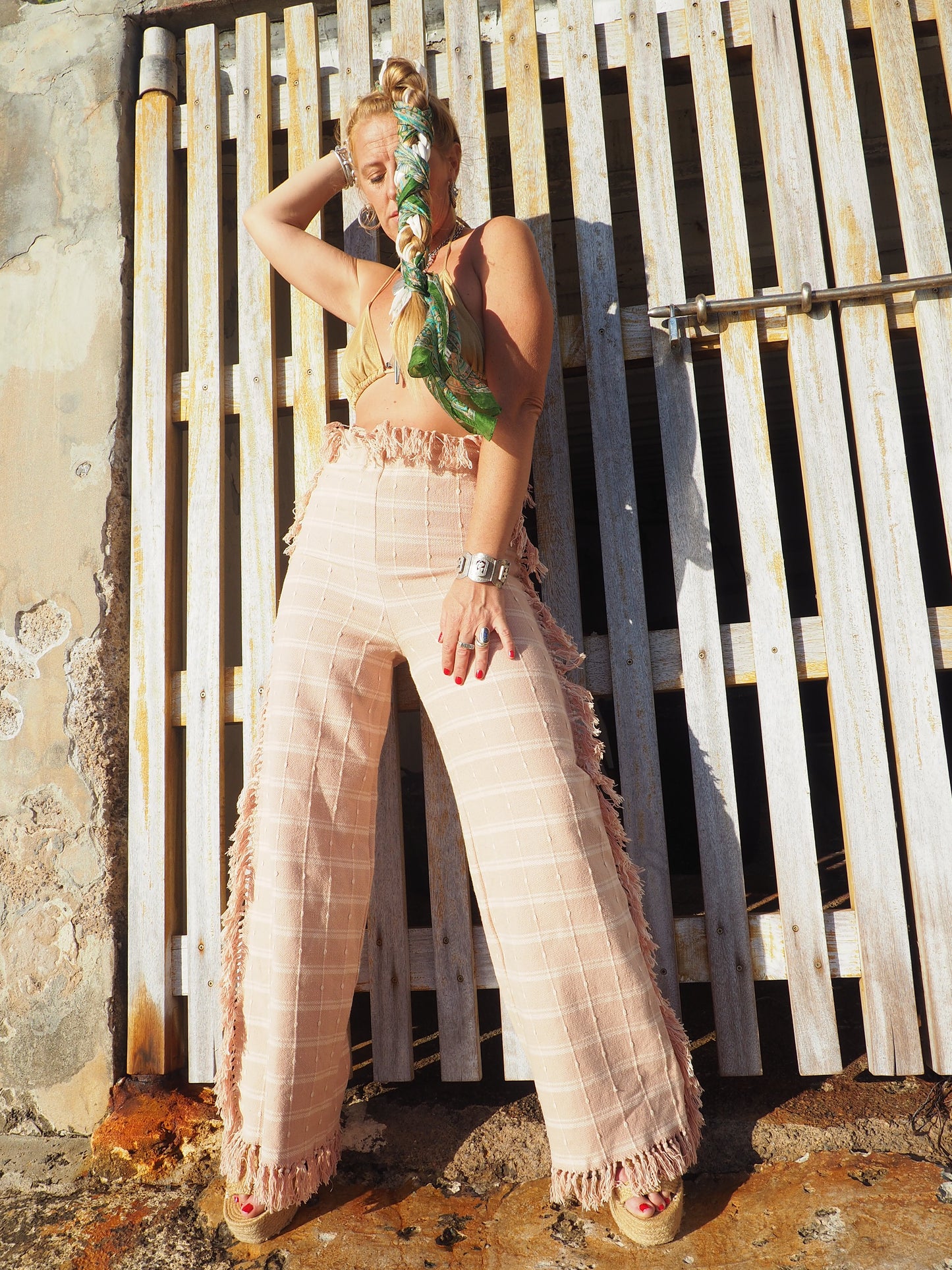 Wide leg pants with elastic waste made by vagabond Ibiza from vintage woven cotton tassel blanket with tassel side trim.