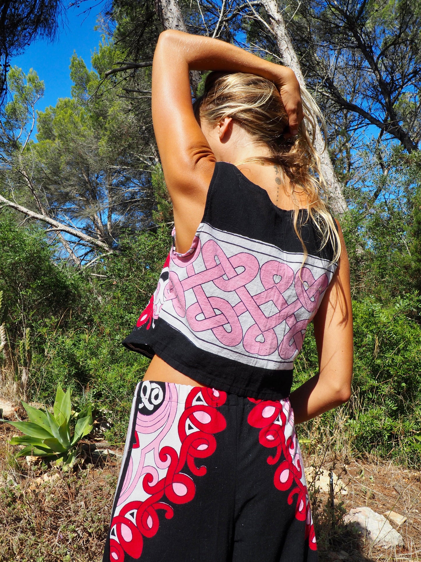 Up-cycled cotton short sleeve crop top in pink and black with vibrant print design and circular motifs by Vagabond Ibiza made