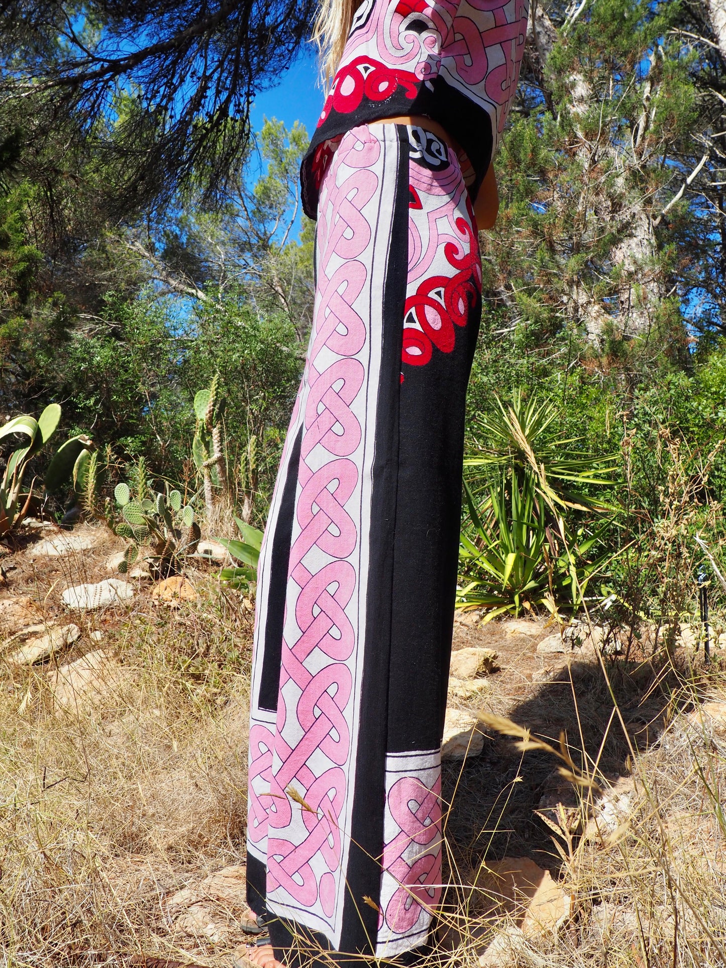 Up-cycled cotton wide leg pants pink and black with vibrant print design and circular motifs by Vagabond Ibiza