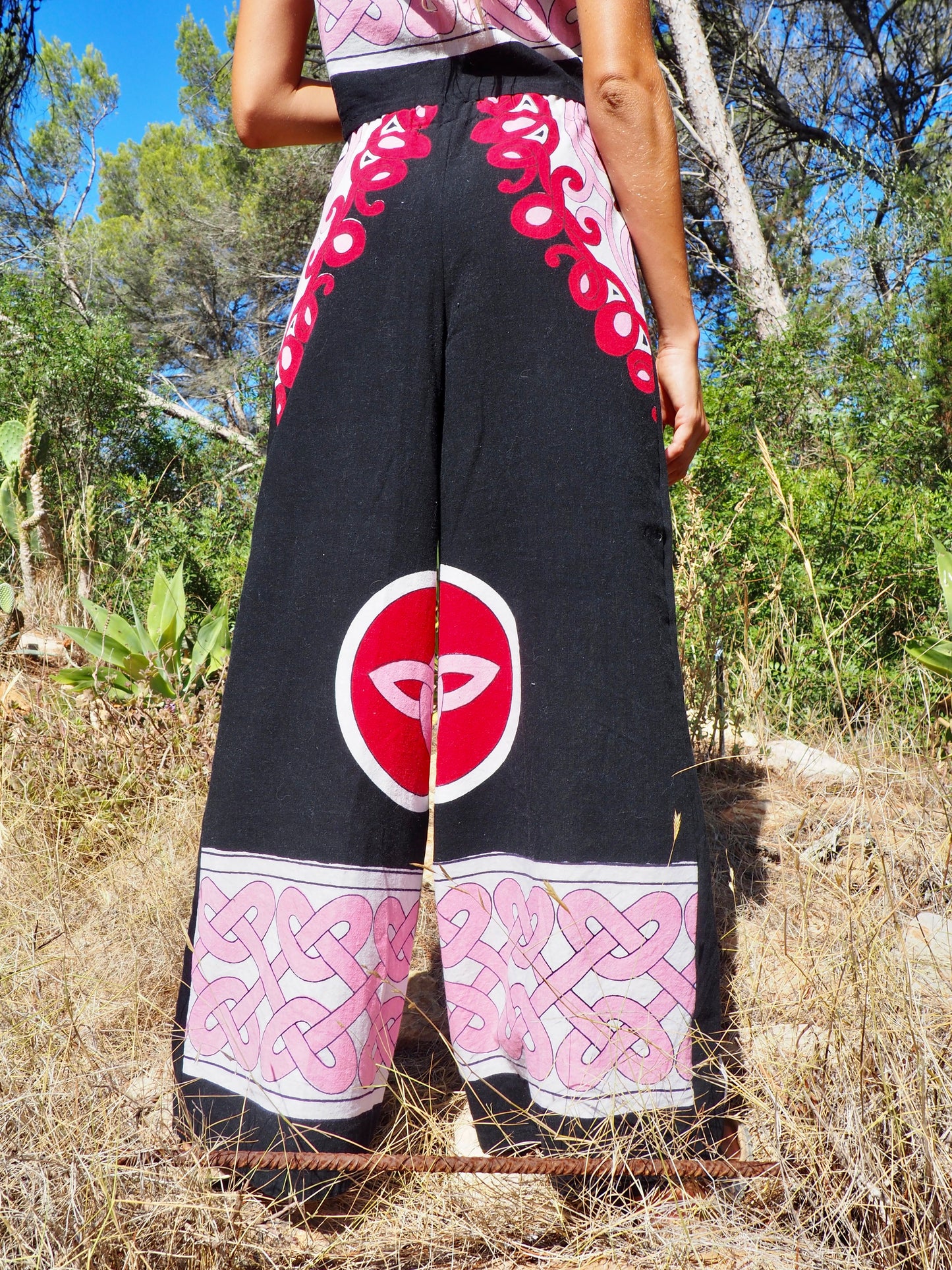 Up-cycled cotton wide leg pants pink and black with vibrant print design and circular motifs by Vagabond Ibiza