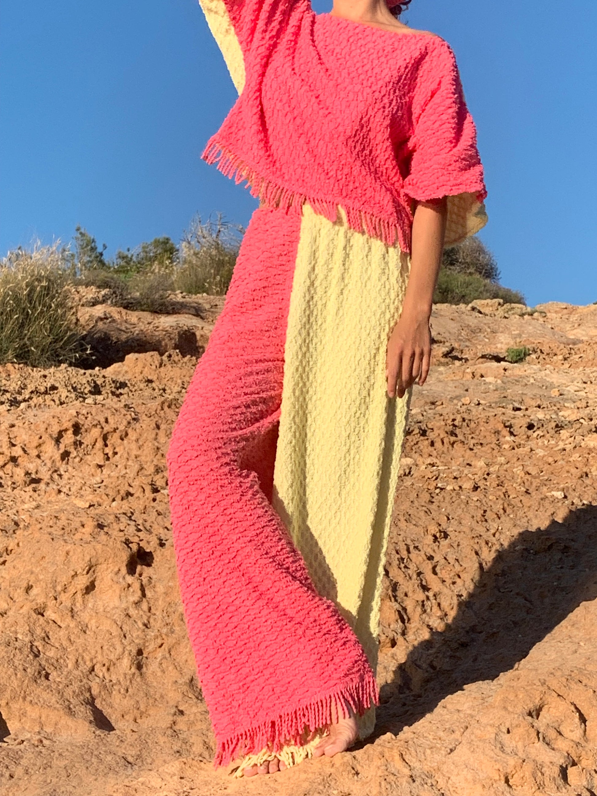 Handmade pastel patchwork towel set in pink and yellow, featuring long sleeve top and wide-leg trousers, upcycled in Ibiza.
