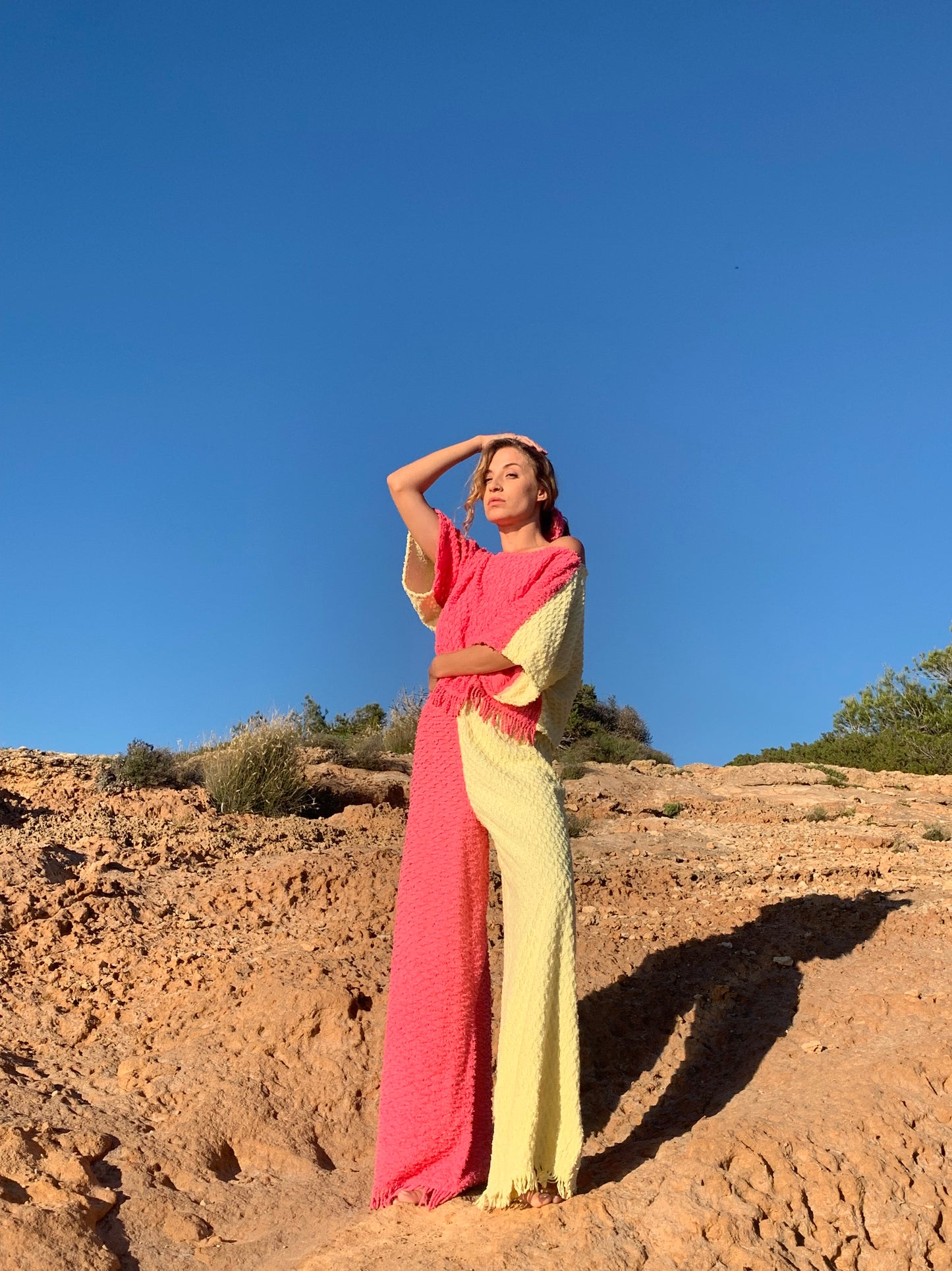 Handmade pastel patchwork towel set in pink and yellow, featuring long sleeve top and wide-leg trousers, upcycled in Ibiza.
