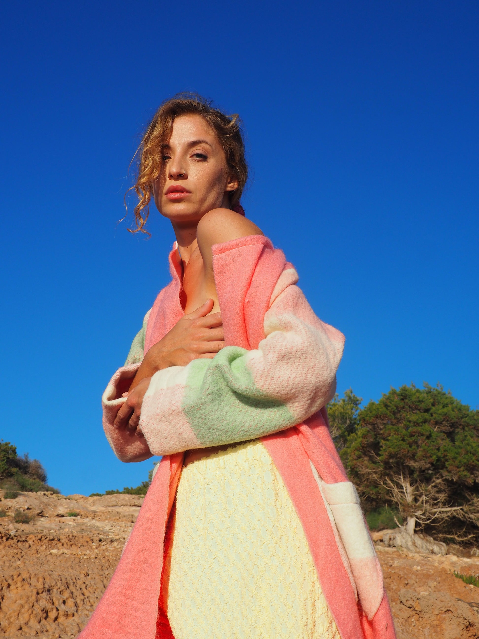 Recycled pastel patchwork jacket with checked sleeves and pink body, made from vintage blankets
