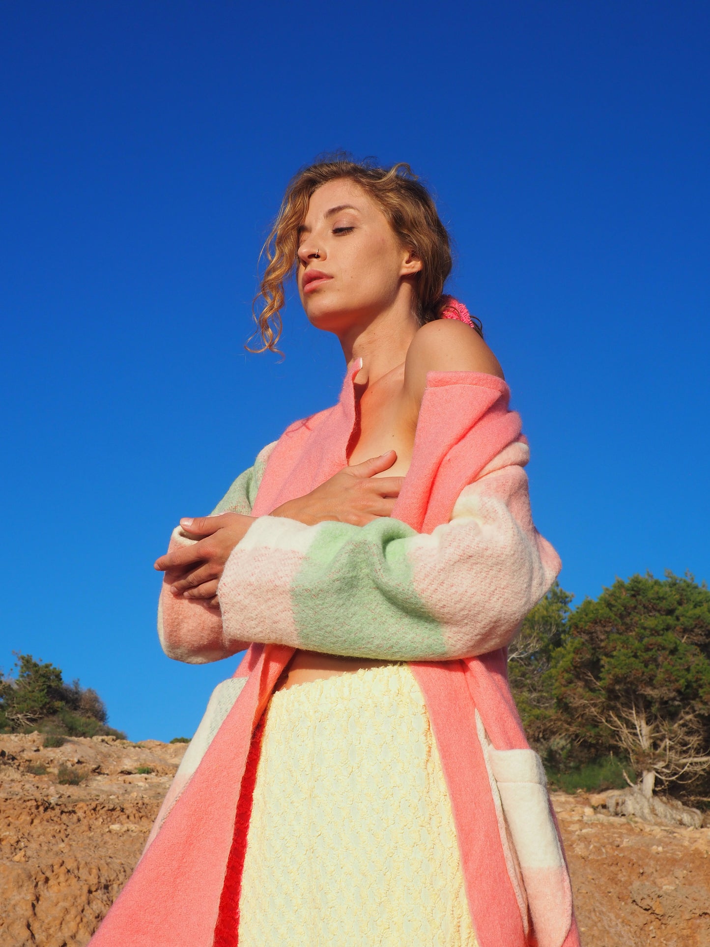 Recycled pastel patchwork jacket with checked sleeves and pink body, made from vintage blankets
