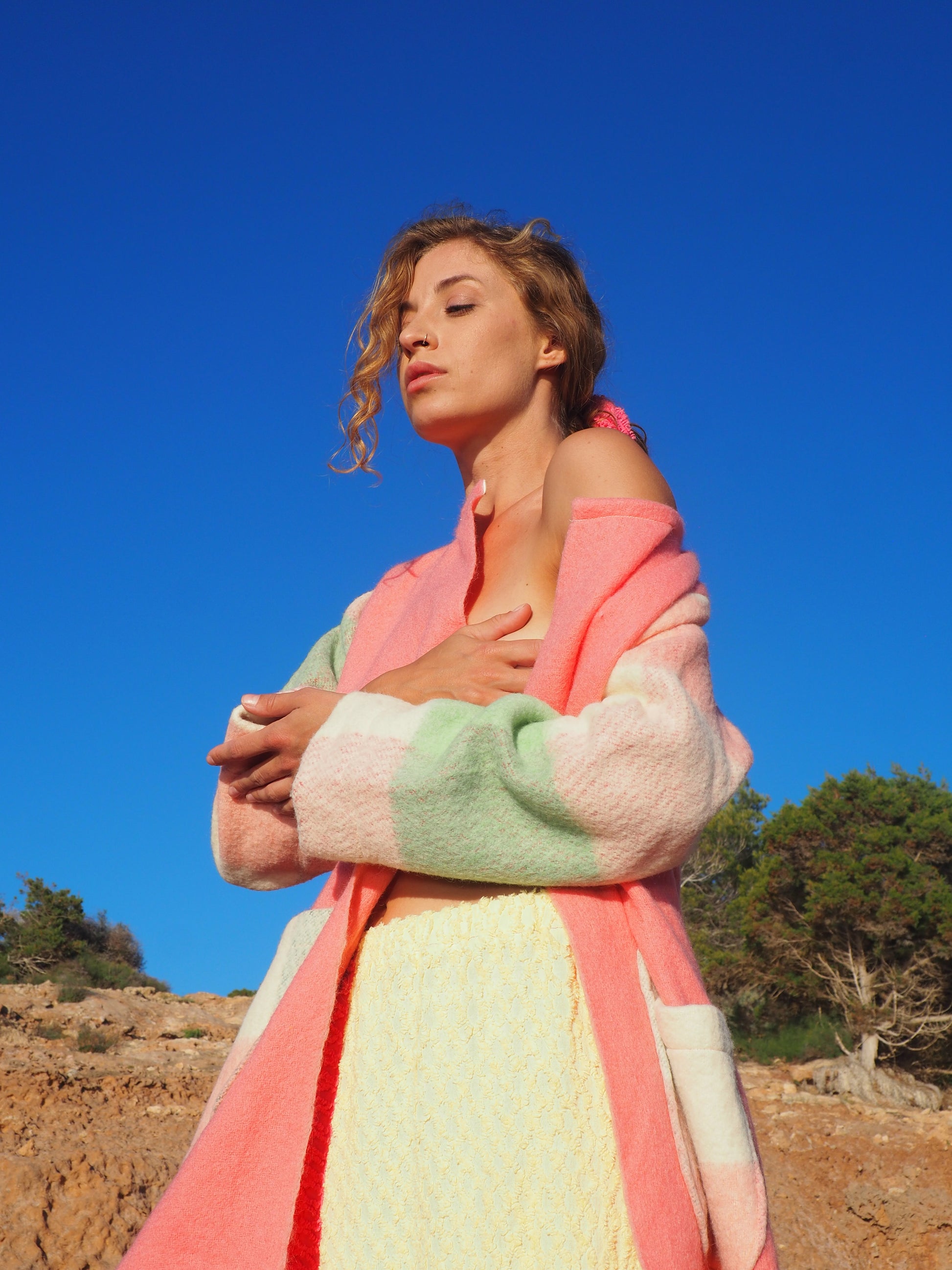 Recycled pastel patchwork jacket with checked sleeves and pink body, made from vintage blankets
