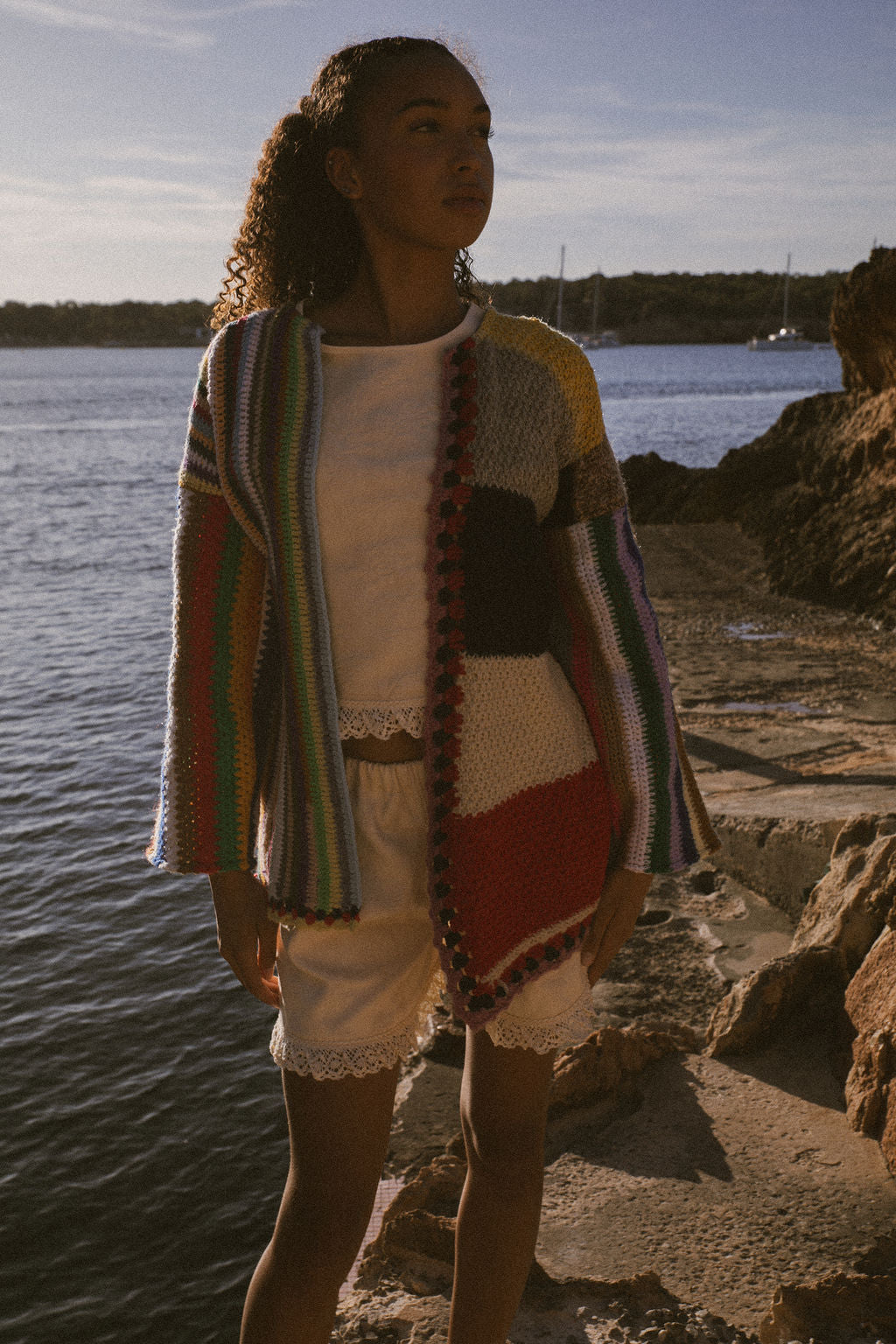 Rainbow striped patchwork upcycled crochet jacket made from vintage blankets, handmade in Ibiza.