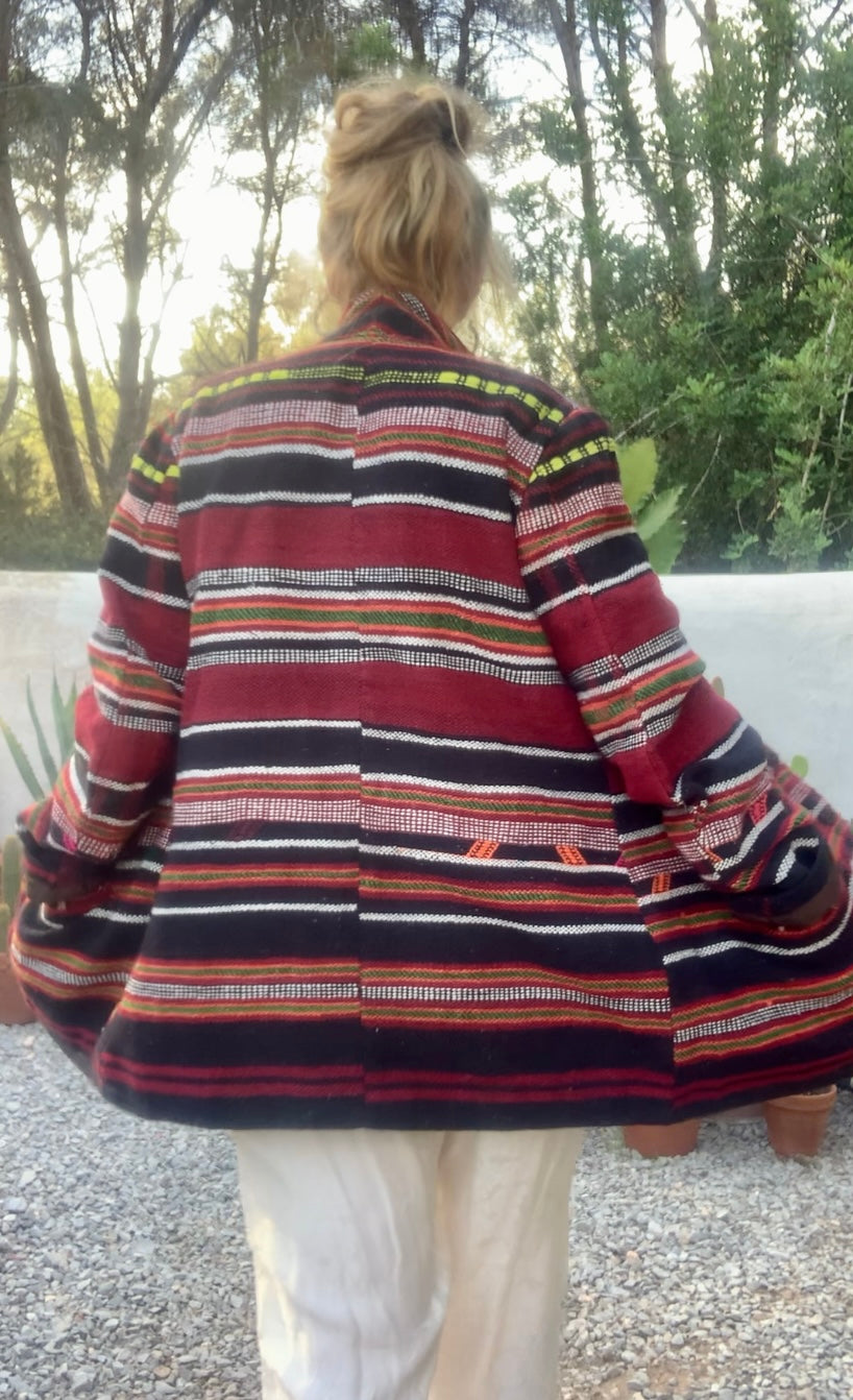 Original vintage woven Moroccan blanket jacket with red and black stripped design pockets and buttons up the front lined with black cotton