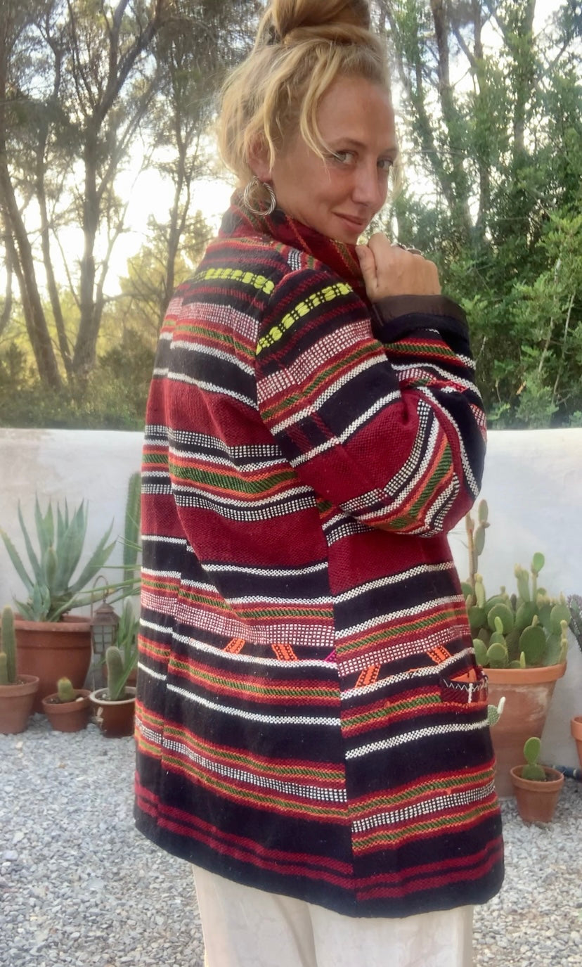 Original vintage woven Moroccan blanket jacket with red and black stripped design pockets and buttons up the front lined with black cotton